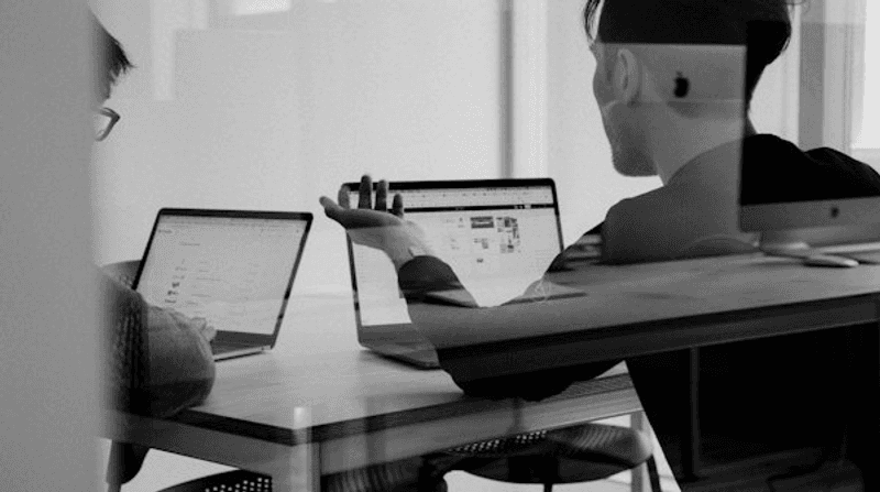 Team evaluating AI testing tools on laptops